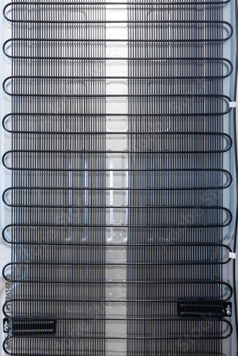 Back wall of the domestic refrigerator with grille. vertical
