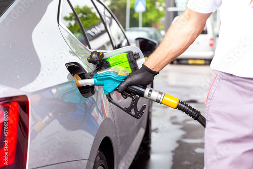 Filling diesel fuel in car at gas station