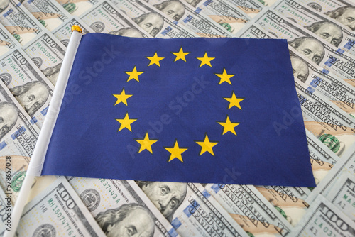 economy of the European Union. EU flag on US dollar banknotes money, Business and finance concept in europe.
