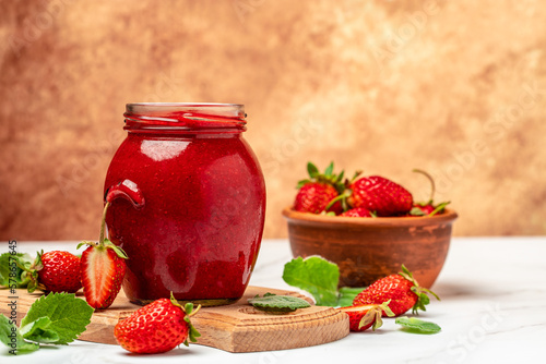 strawberry jam in a jar and fresh berries on white table. banner, menu, recipe place for text