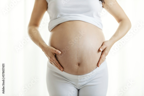 Close up of a pregnant woman showing her tummy before childbirth.