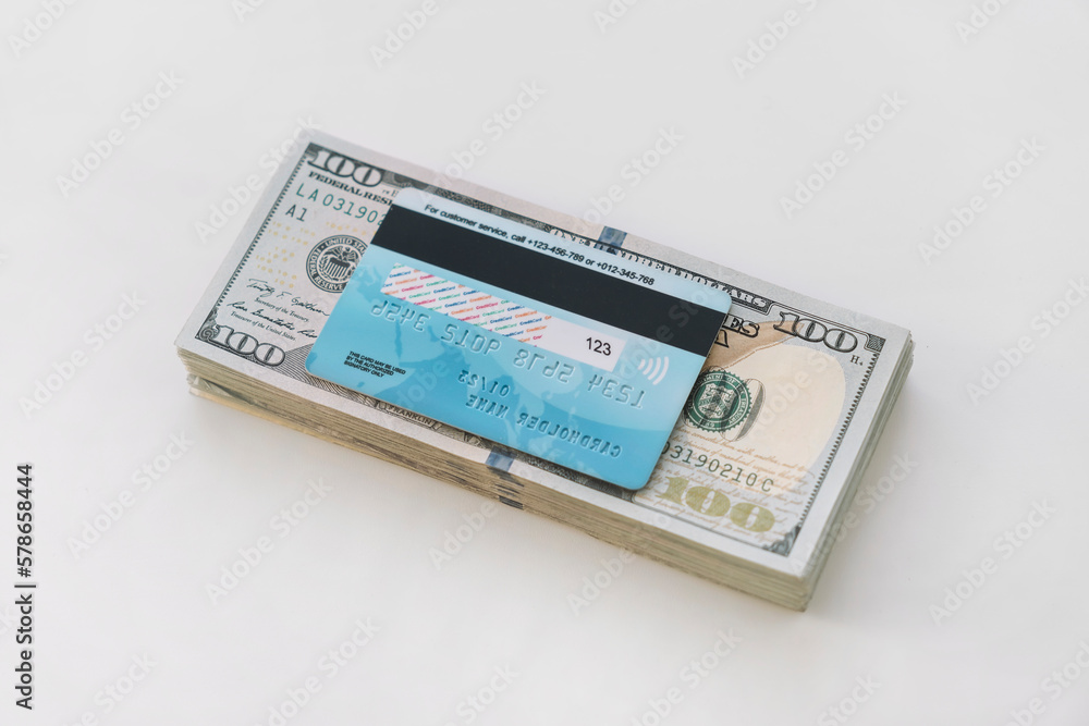 Credit card on US dollar banknotes. Finance development, Banking Account, Statistics, Investment Analytic research data economy, Stock exchange trading, Business company concept. on white background Credit card on US dollar banknotes. Finance development, Banking Account, Statistics, Investment Analytic research data economy, Stock exchange trading, Business company concept. on white background
