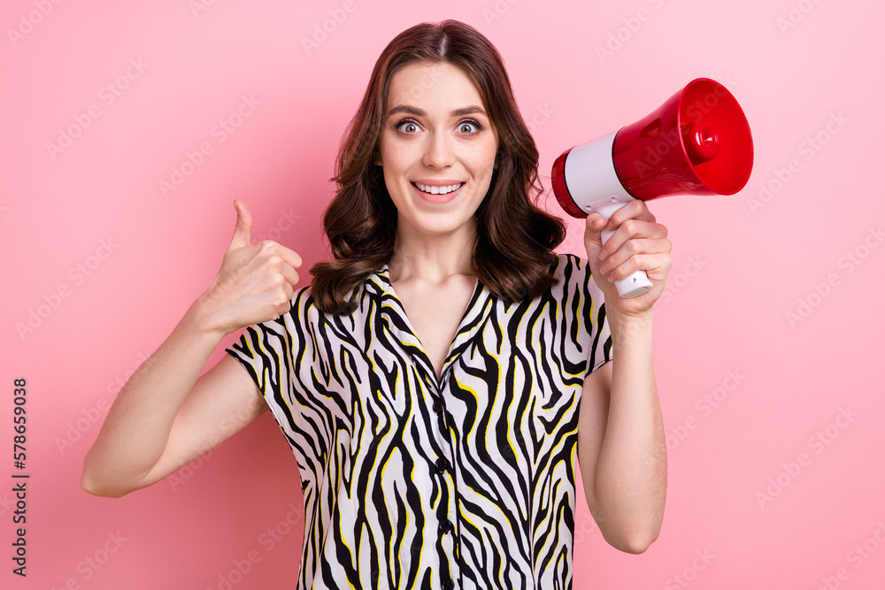 Portrait of nice cheerful lady hand hold loudspeaker demonstrate thumb up isolated on pink color background Portrait of nice cheerful lady hand hold loudspeaker demonstrate thumb up isolated on pink color background