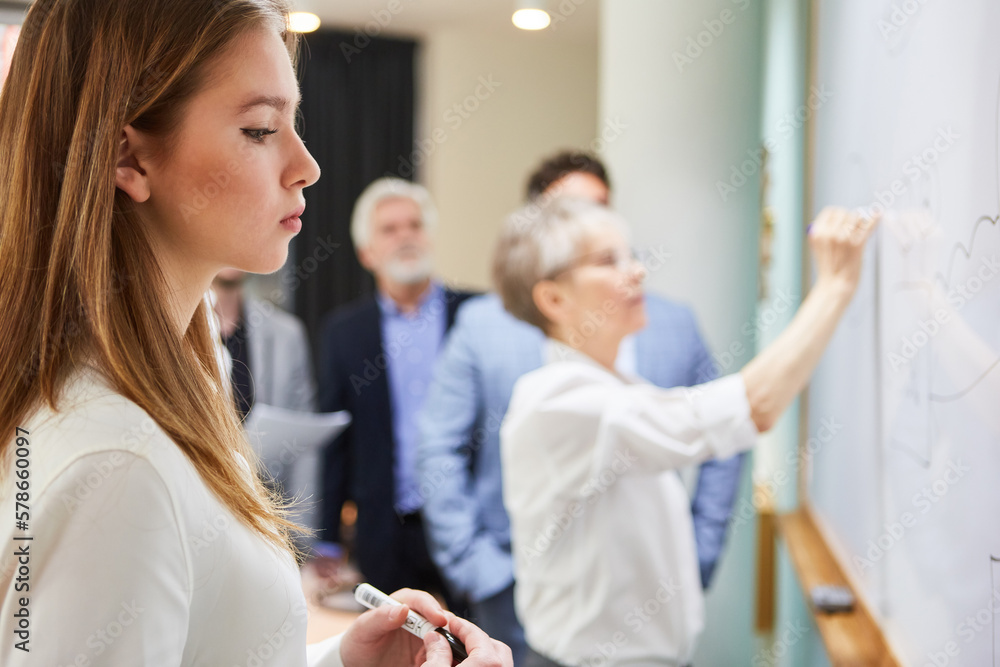 Fototapeta premium Female student brainstorm workshop on whiteboard
