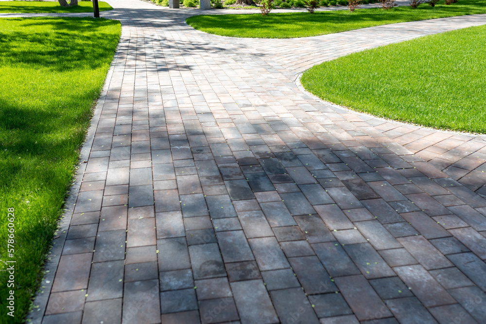 Paving with paving slabs. Landscape architecture of a park. Decorative