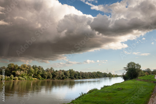 Panorama of the tisza river at dusk, during a sunny evening, in the riverbank of Szeged, Hungary, a hungarian city. Tisza, or Tisa, is the main hungarian river