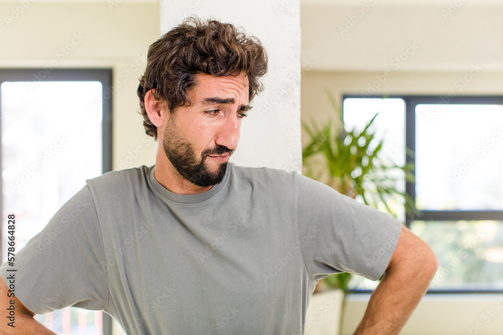 young adult crazy man with expressive pose at a modern house interior young adult crazy man with expressive pose at a modern house interior