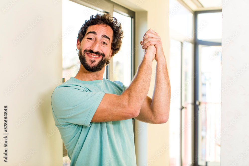 young adult crazy man with expressive pose at a modern house interior young adult crazy man with expressive pose at a modern house interior