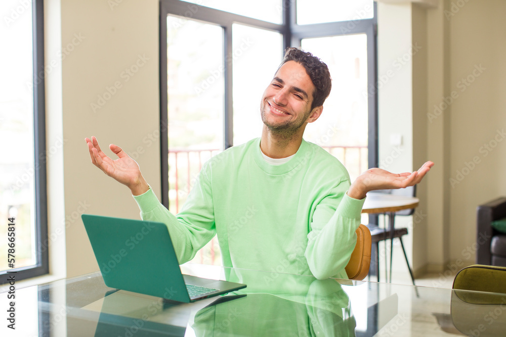 young hispanic man smiling cheerfully giving a warm, friendly, loving welcome hug, feeling happy and adorable. working at home young hispanic man smiling cheerfully giving a warm, friendly, loving welcome hug, feeling happy and adorable. working at home