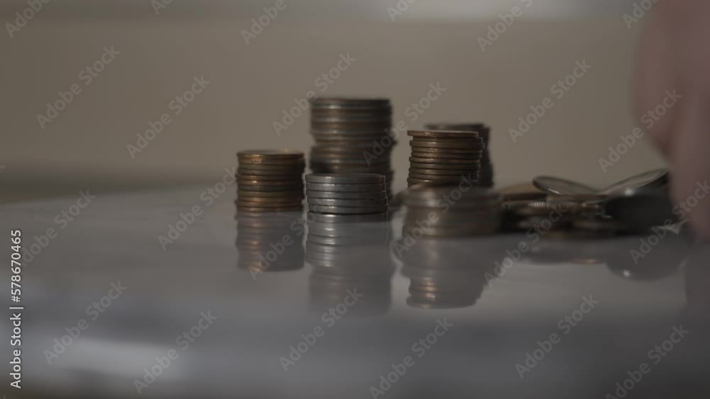 Coins drooping into frame in Slow Motion.