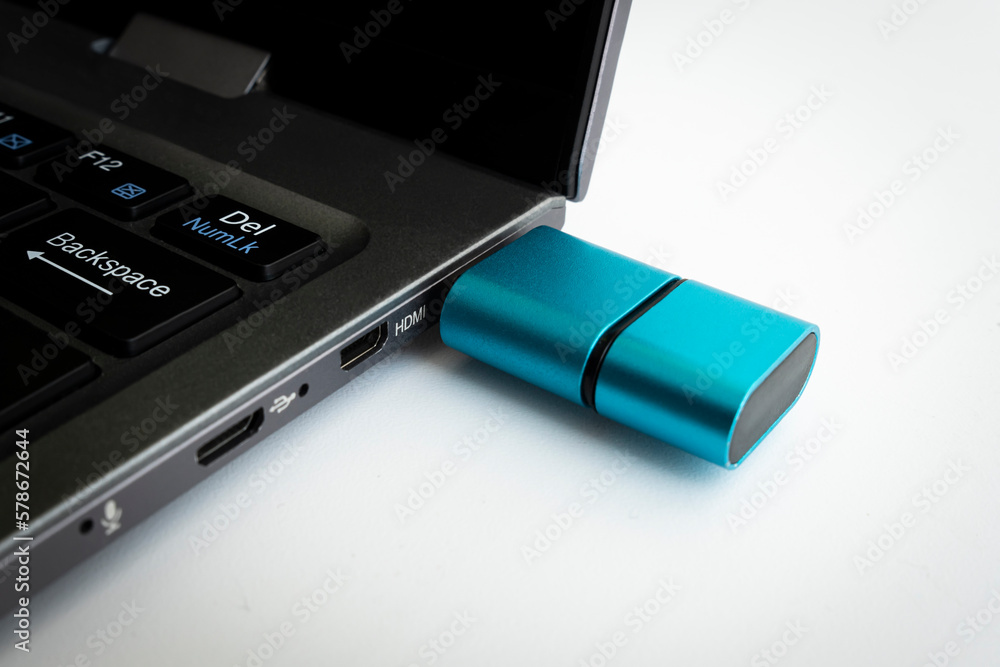 the flash drive is plugged into the laptop connector in close-up. Card Reader Type C on white background the flash drive is plugged into the laptop connector in close-up. Card Reader Type C on white background