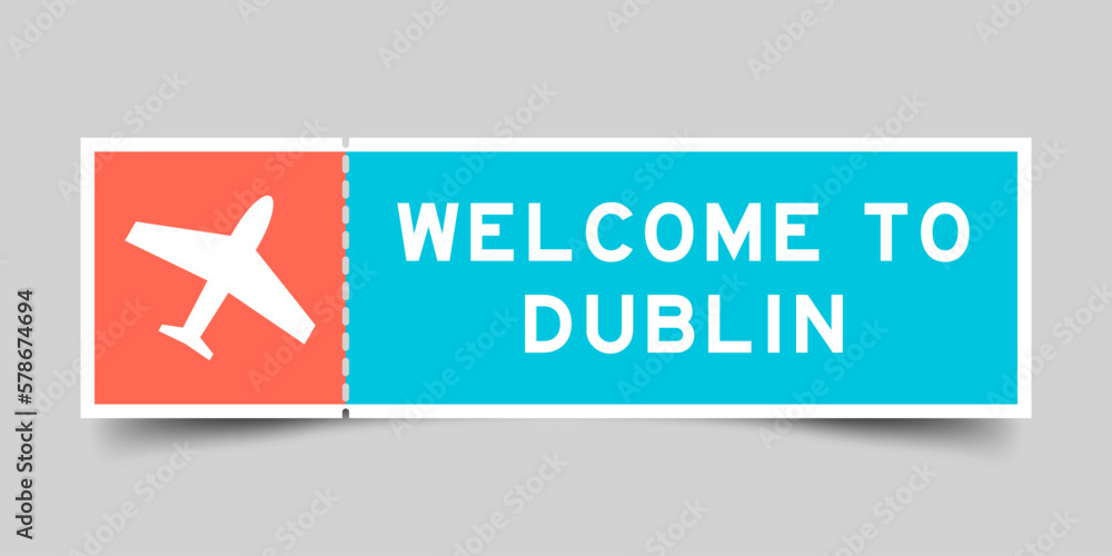 Fototapeta premium Orange and blue color ticket with plane icon and word welcome to dublin on gray background