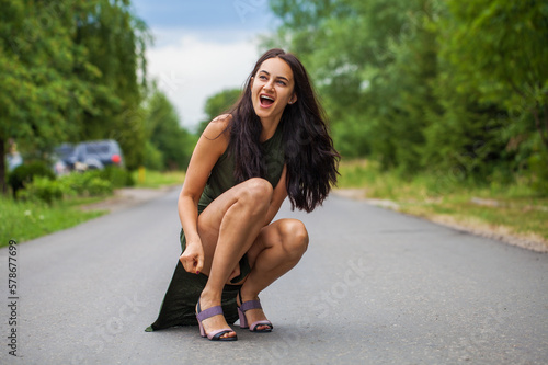  beautiful brunette woman sitting on the road