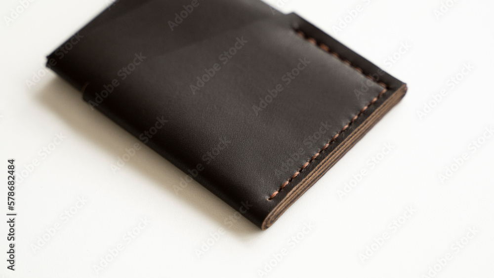 Brown empty men's business handmade genuine leather card holder with isolated on white background. Selective focus, copy space, close up. Brown empty men's business handmade genuine leather card holder with isolated on white background. Selective focus, copy space, close up.