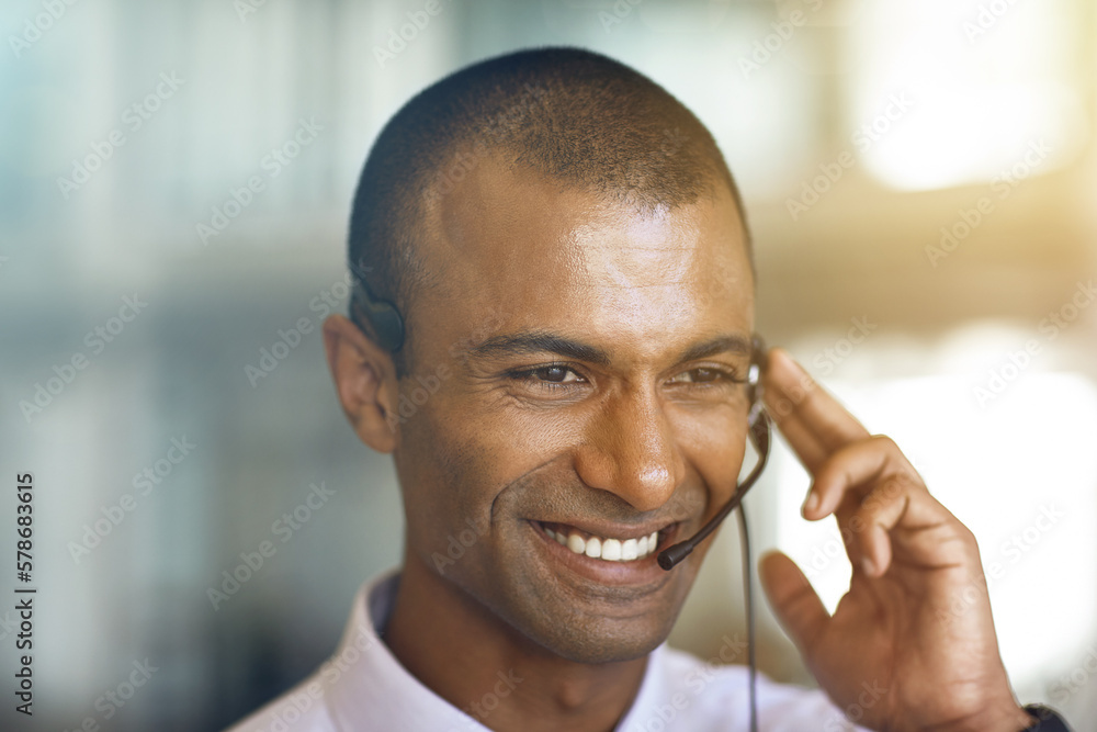 Customer service at its best. a businessman communicating using his handsfree headset. Customer service at its best. a businessman communicating using his handsfree headset.