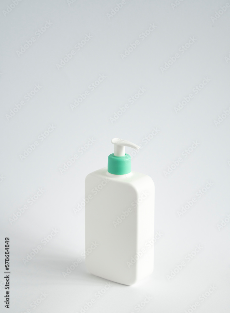 Large white plastic bottle with pump dispenser as a liquid container for gel, lotion, cream, shampoo, bath foam on white background. Large white plastic bottle with pump dispenser as a liquid container for gel, lotion, cream, shampoo, bath foam on white background.
