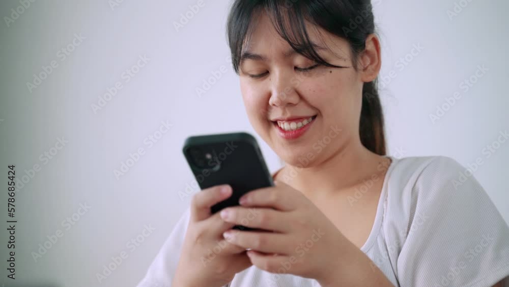 Happy woman is typing on the mobile phone screen. Happy woman is typing on the mobile phone screen.