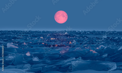 Fototapeta Naklejka Na Ścianę i Meble -  Beautiful winter landscape of frozen Lake Baikal with Super Full Moon - Snowy ice hummocks with transparent blue piles of ice - Baikal Lake, Siberia 