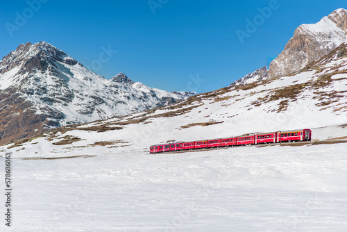 Bernina express train in winter snow mountains