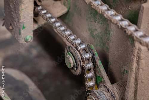 Farm planter chain and gear sprocket. Farming equipment maintenance, repair and service concept.