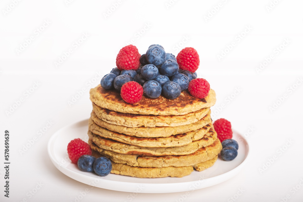 Delicious freshly cooked thick and fluffy protein pancakes served on white plate whith fresh fruit. Healthy food, low carb diet. Delicious freshly cooked thick and fluffy protein pancakes served on white plate whith fresh fruit. Healthy food, low carb diet.