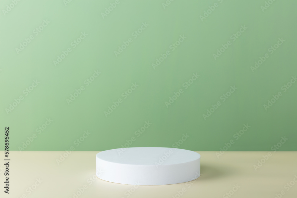 Abstract empty white podium with palm leaves on beige background Abstract empty white podium with palm leaves on beige background