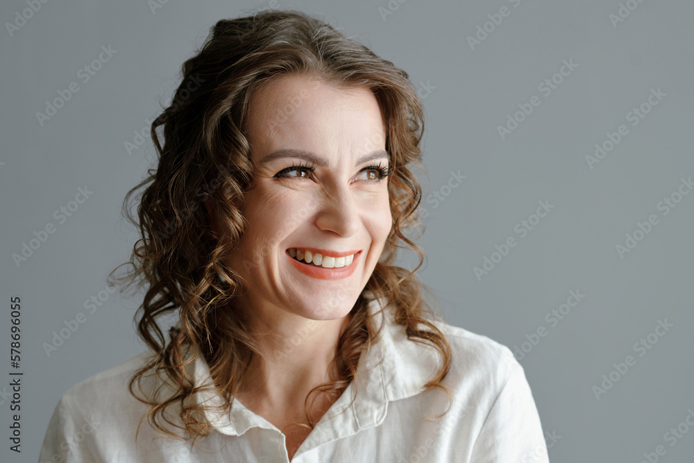 Fototapeta premium Portrait of smiling mature woman looking away