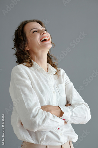 Happy mature woman throwing head back laughing