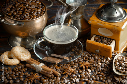 Espresso coffee with coffee beans on old background.