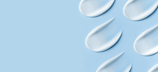 cosmetic smears cream texture on blue background