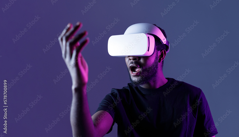 African American guy in Smart glasses of virtual reality. Augmented reality game, future technology, AI concept. VR. Neon light. African American guy in Smart glasses of virtual reality. Augmented reality game, future technology, AI concept. VR. Neon light.