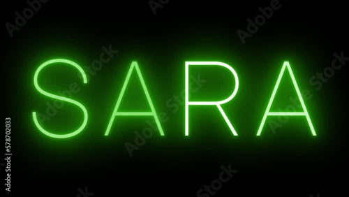 Flickering green retro style neon sign glowing against a black background