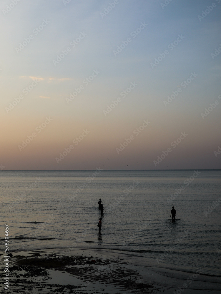 silhouette of peoples at the beach during sunset
