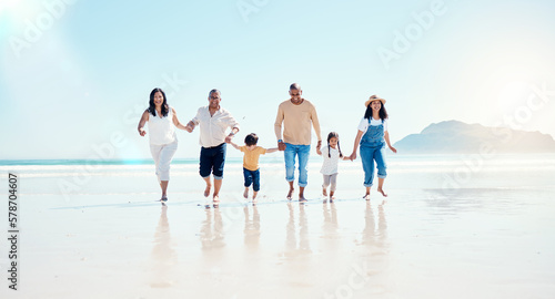 Beach  walking and mockup with a black family holding hands outdoor in nature by the ocean at sunset together. Nature  love or kids with grandparents  parents and children taking a walk on the coast