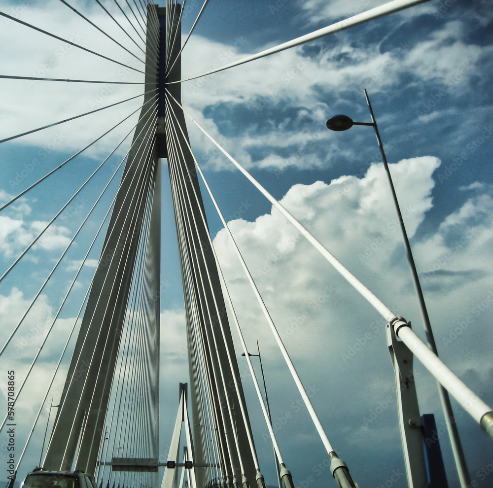 Naklejka premium Driving across Rio-Antirio bridge in Greece on a cloudy day looking up