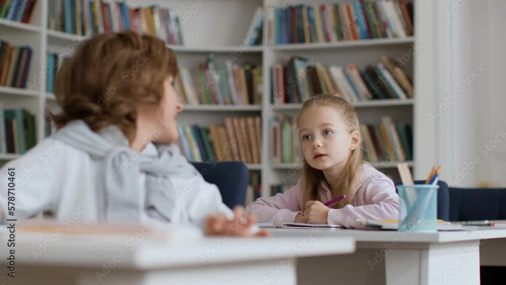 Cheating at school. Little boy can't remember test answer, turning to classmate for help, girl showing right answers Cheating at school. Little boy can't remember test answer, turning to classmate for help, girl showing right answers