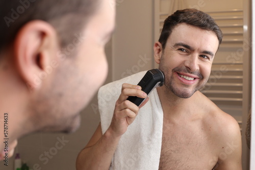 Man shaving in front of the mirror 