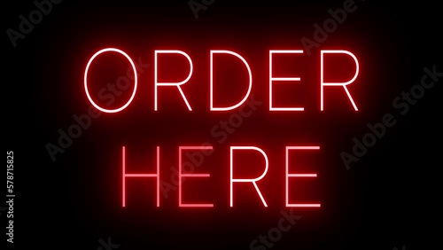 Flickering red retro style neon sign glowing against a black background