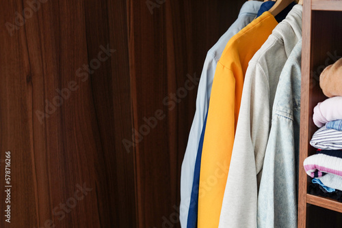 Wardrobe closet with different stylish clothes at home, copy space