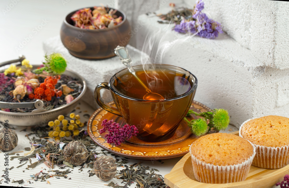 Sweet, hot tea with dry tea leaves, on an old background. Sweet, hot tea with dry tea leaves, on an old background.
