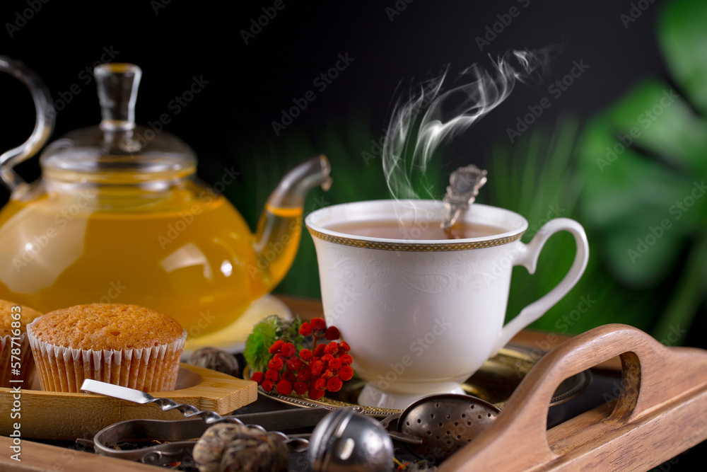 Fototapeta premium Dry tea leaves in a spoon on an old background