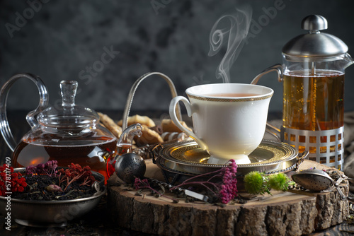 Hot sweet tea in a cup on old background