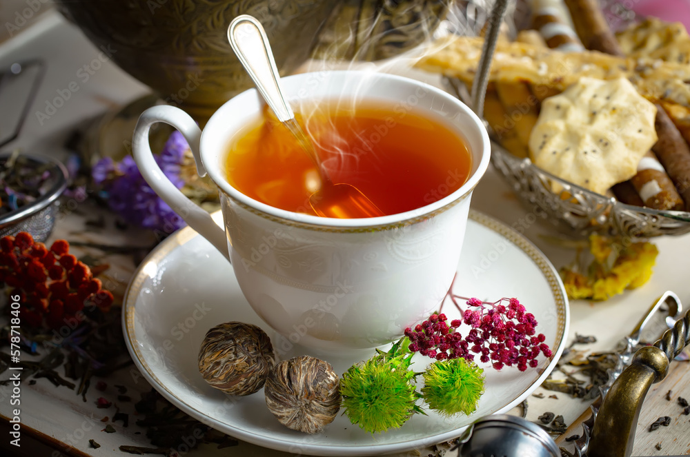 Sweet, hot tea with dry tea leaves, on an old background. Sweet, hot tea with dry tea leaves, on an old background.