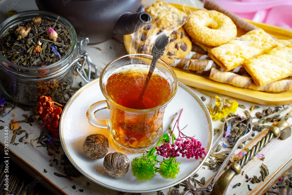 Sweet, hot tea with dry tea leaves, on an old background. Sweet, hot tea with dry tea leaves, on an old background.