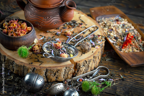 Dried tea leaves in a spoon, on an old background. © Karnav