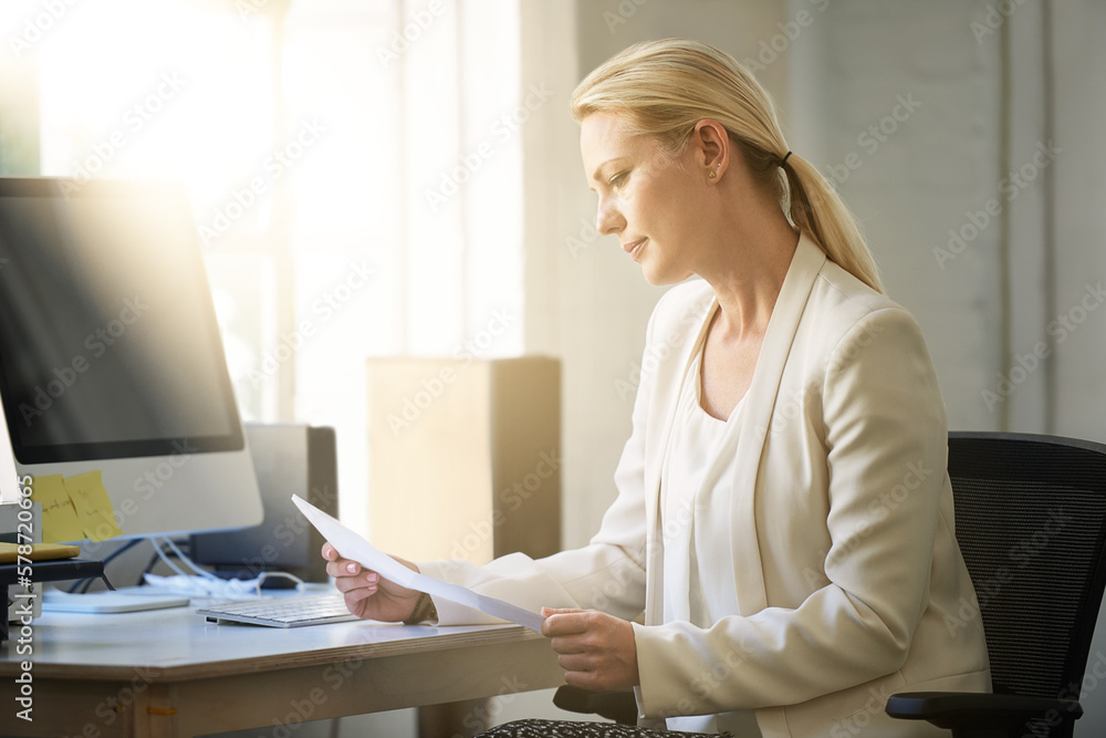 Making sure everything goes according to plan. Portrait of a woman working on paperwork in her office. Making sure everything goes according to plan. Portrait of a woman working on paperwork in her office.