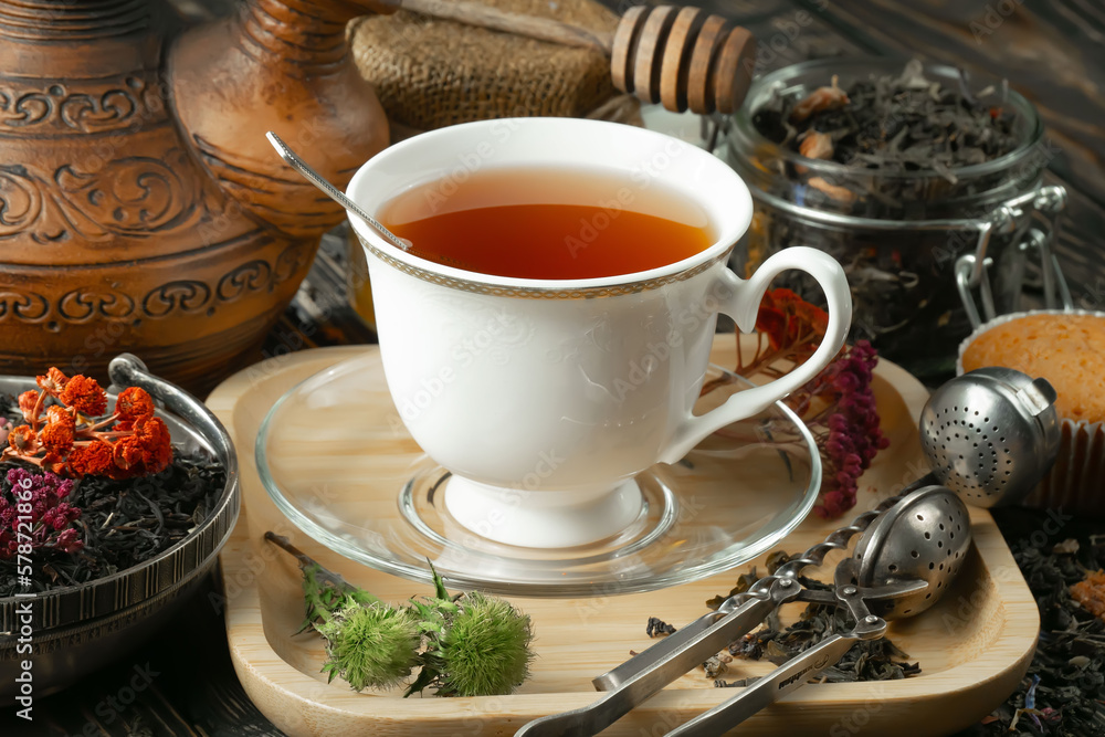 Sweet, hot tea with dry tea leaves, on an old background. Sweet, hot tea with dry tea leaves, on an old background.
