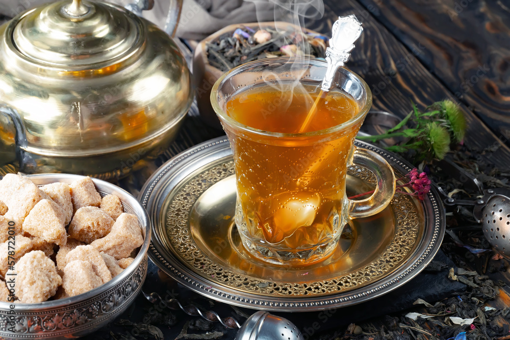 Hot sweet tea in a cup on old background Hot sweet tea in a cup on old background