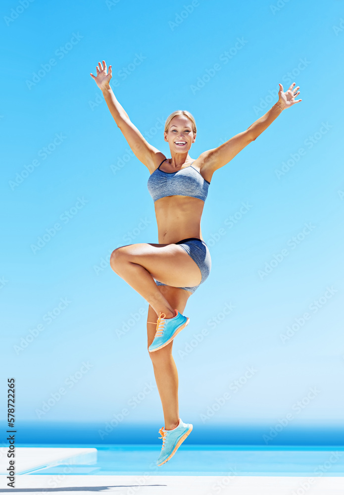 Fit and free. a young woman in workout gear jumping in the air. Fit and free. a young woman in workout gear jumping in the air.