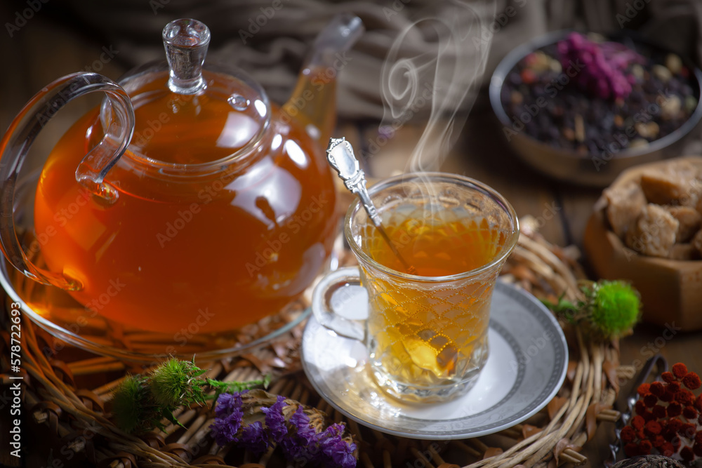 Sweet, hot tea with dry tea leaves, on an old background. Sweet, hot tea with dry tea leaves, on an old background.